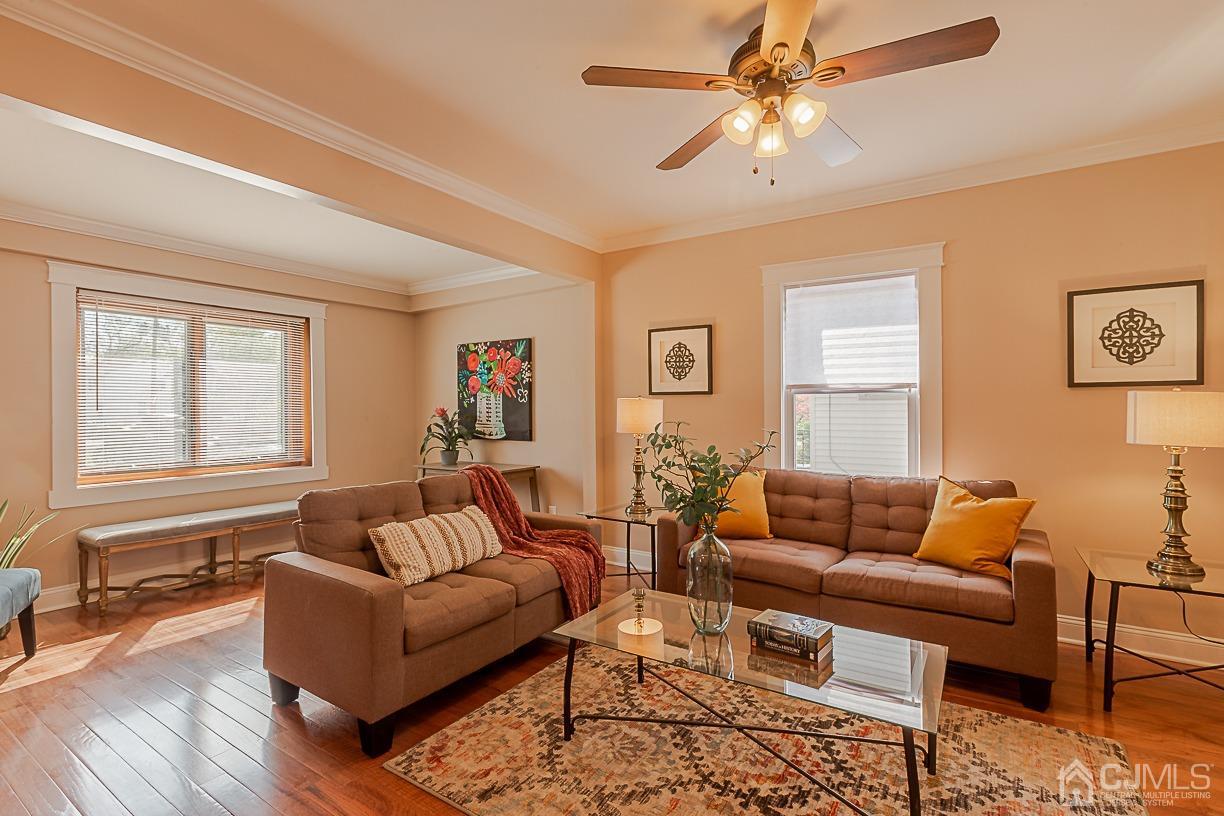150 New Market Road Dunellen, NJ 08812 - Photo 3 of 22 a living room with furniture a ceiling fan a rug and a window