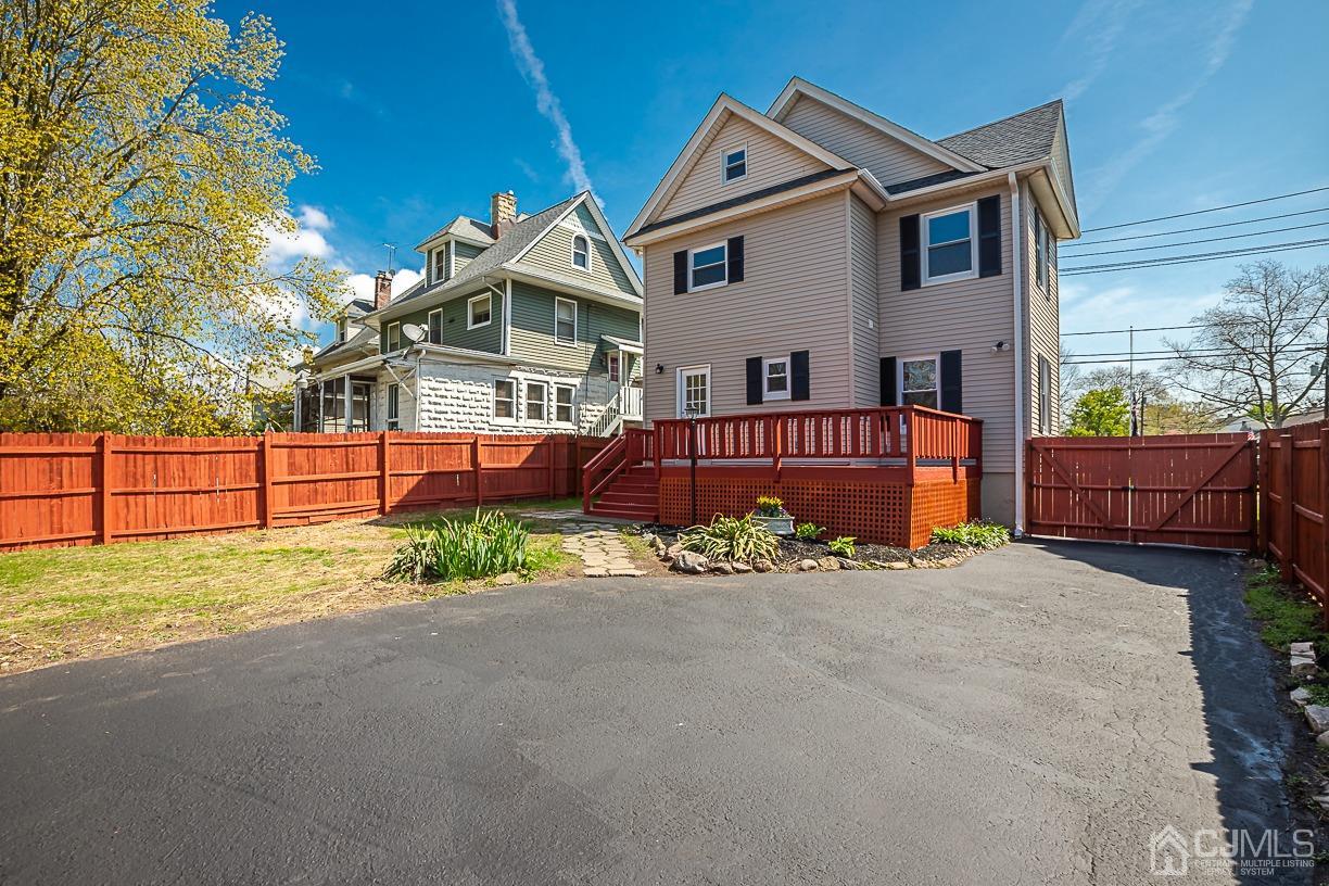150 New Market Road Dunellen, NJ 08812 - Photo 22 of 22 a front view of a house with a yard with potted plants