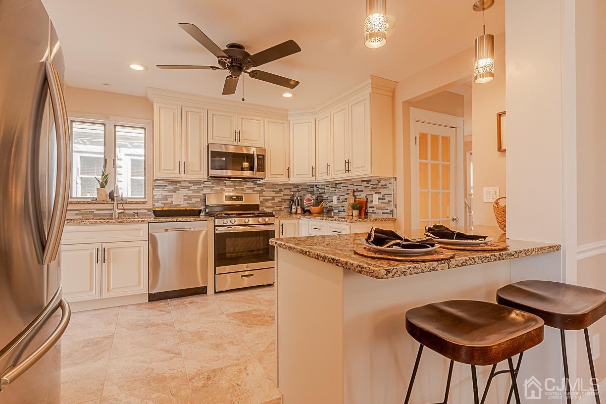 150 New Market Road Dunellen, NJ 08812 - Photo 8 of 22 a kitchen with appliances cabinets and a stove top oven