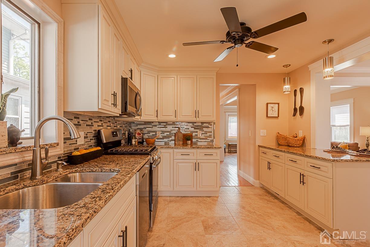 150 New Market Road Dunellen, NJ 08812 - Photo 9 of 22 a kitchen with stainless steel appliances granite countertop a sink stove and refrigerator