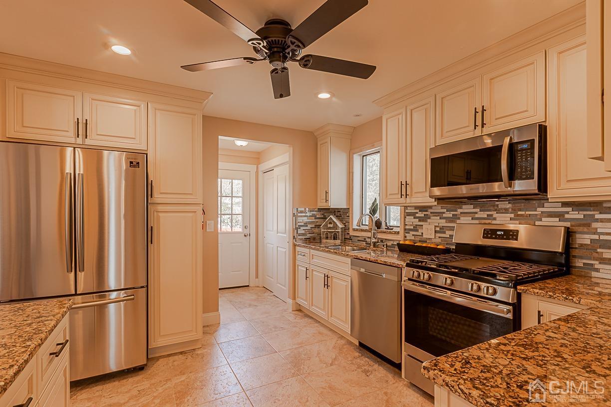 150 New Market Road Dunellen, NJ 08812 - Photo 10 of 22 a kitchen with stainless steel appliances a refrigerator stove and microwave