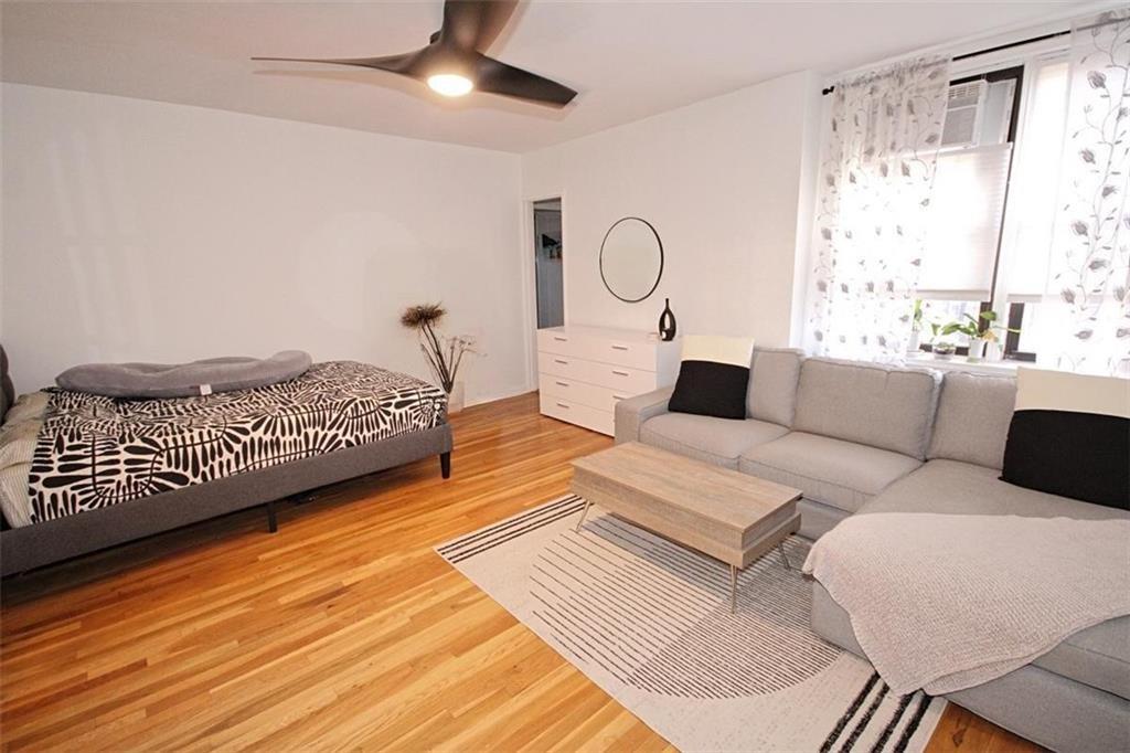 7259 Shore Road, Unit 5A Brooklyn, NY 11209 - Photo 17 of 18 a living room with furniture a lamp and a rug