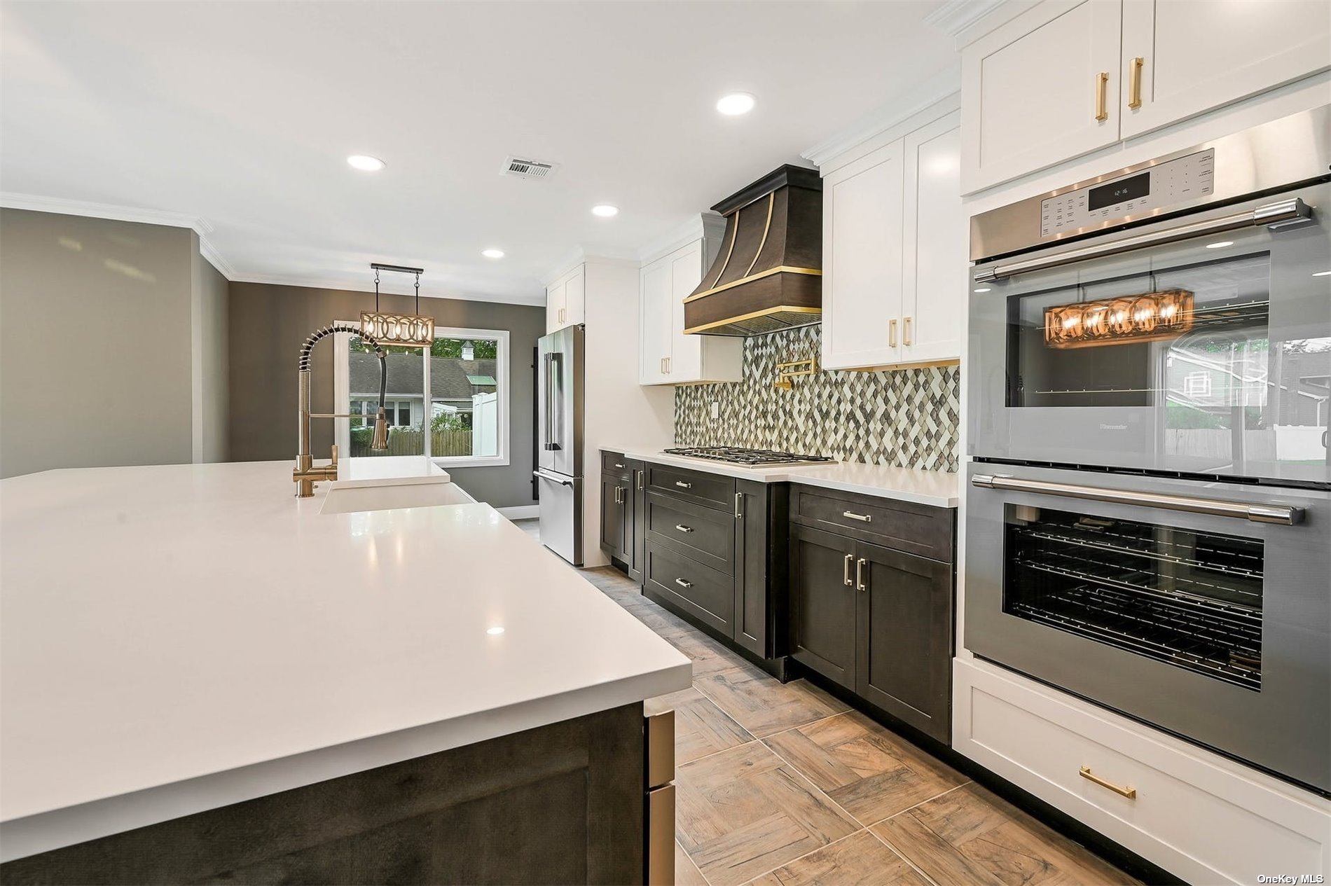 a kitchen with stainless steel appliances kitchen island granite countertop a stove top oven and sink