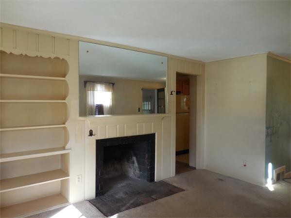 51 Pilgrim Road Springfield, MA 01118 - Photo 8 of 20 a view of a livingroom with an empty space and a fireplace