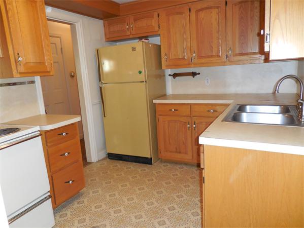 51 Pilgrim Road Springfield, MA 01118 - Photo 10 of 20 a kitchen with a refrigerator sink and cabinets