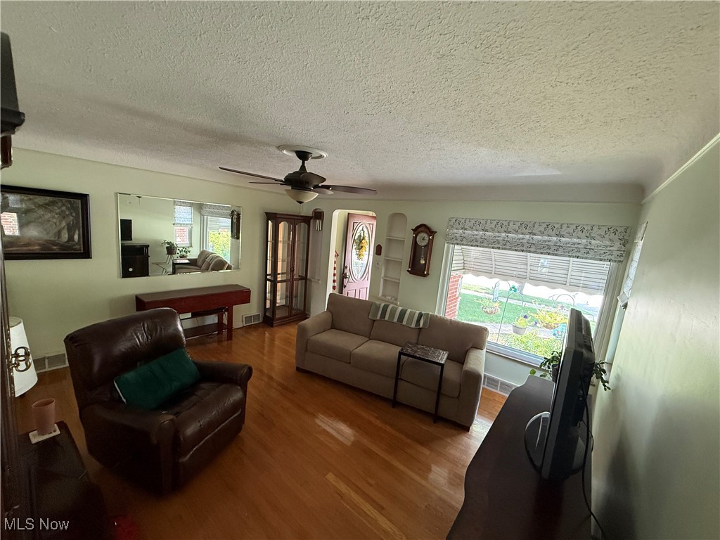 6289 Manchester Road Parma, OH 44129 - Photo 15 of 46 Living room with a textured ceiling, wood finished floors, and ceiling fan