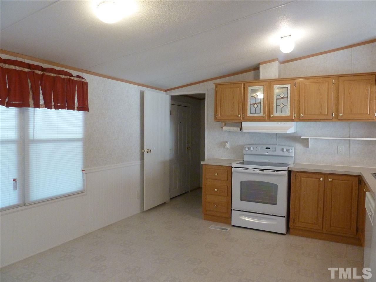 162 Isaac Trail Roxboro, NC 27574 - Photo 11 of 20 a kitchen with stainless steel appliances granite countertop a stove a sink and a refrigerator