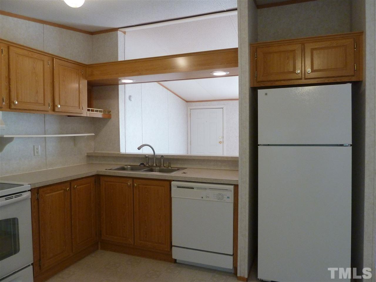 162 Isaac Trail Roxboro, NC 27574 - Photo 13 of 20 a kitchen with stainless steel appliances granite countertop a refrigerator and a sink