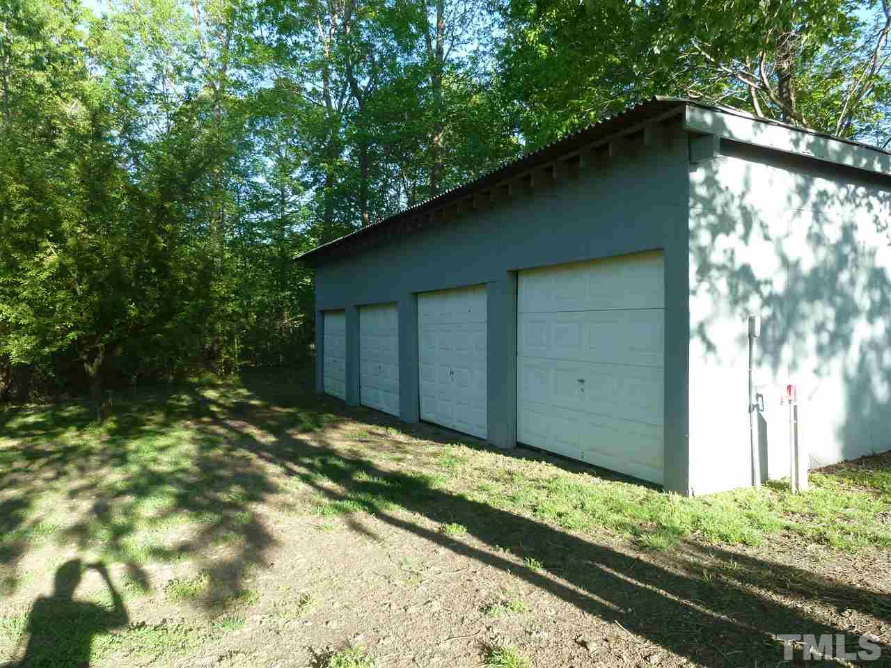 162 Isaac Trail Roxboro, NC 27574 - Photo 3 of 20 a backyard of a house with large trees and a wooden fence