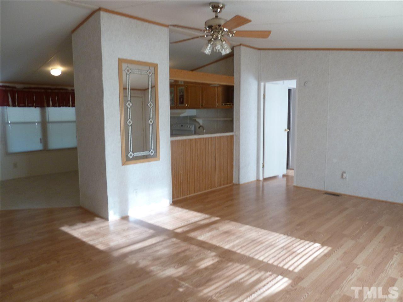 162 Isaac Trail Roxboro, NC 27574 - Photo 10 of 20 a view of a livingroom with a chandelier fan and wooden floor