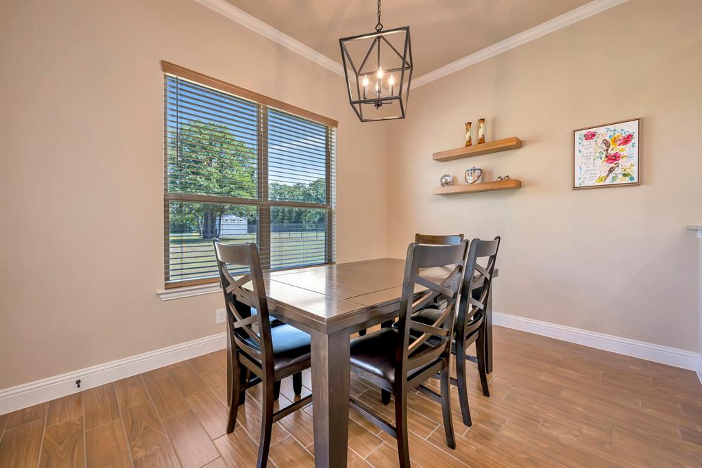 3224 North Cardinal Road Azle, TX 76020 - Photo 14 of 40 Dining area featuring ceramic tile flooring and crown molding