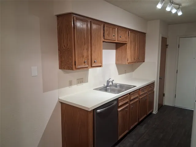 a kitchen with a sink cabinets and a window