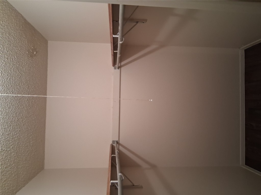 703 Rollingway Drive, Unit B Round Rock, TX 78681 - Photo 7 of 8 a view of a room with racks on the wall