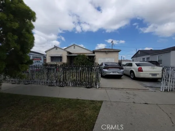 a view of multiple houses with cars parked