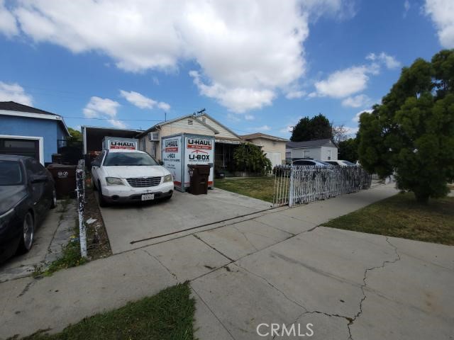 1307 South Grandee Avenue Compton, CA 90220 - Photo 2 of 8 a view of a cars park in front of house