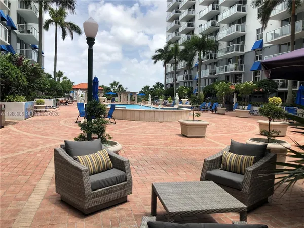 a view of a patio with couches and a fire pit