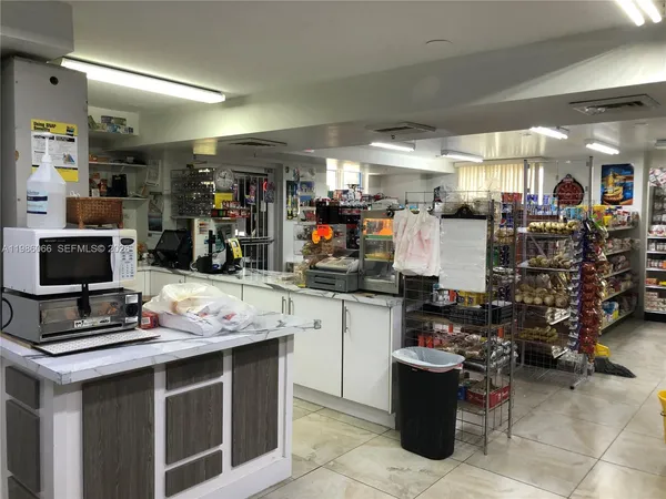 a kitchen with a kitchen island a stove a sink and a refrigerator