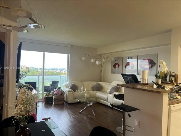a living room with furniture and a large window