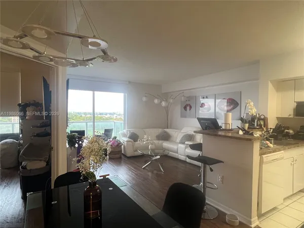 a room with a large window and furniture
