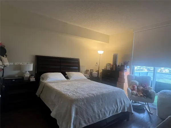 a bedroom with a bed and lamp with window