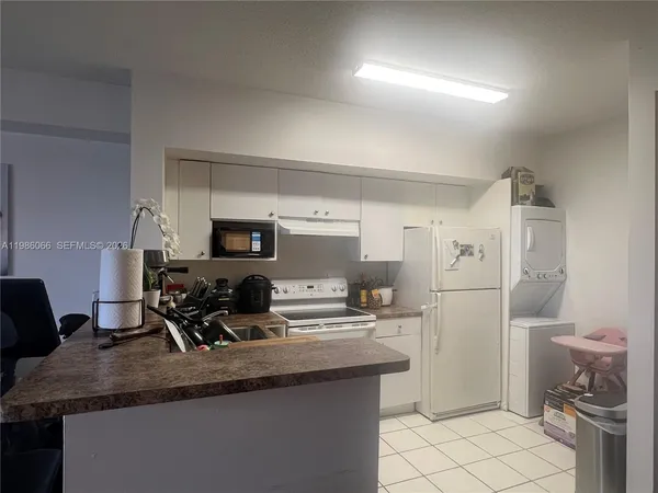 a kitchen with a sink appliances and cabinets
