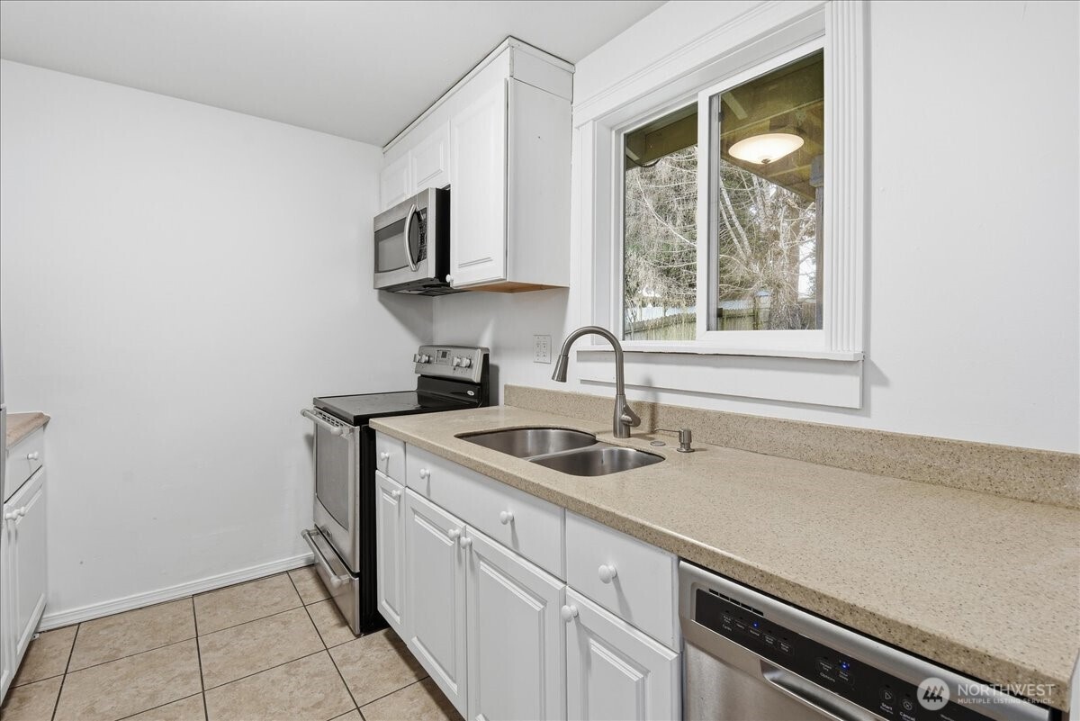 4404 Southeast 3rd Place Renton, WA 98059 - Photo 11 of 27 a kitchen with a sink and cabinets