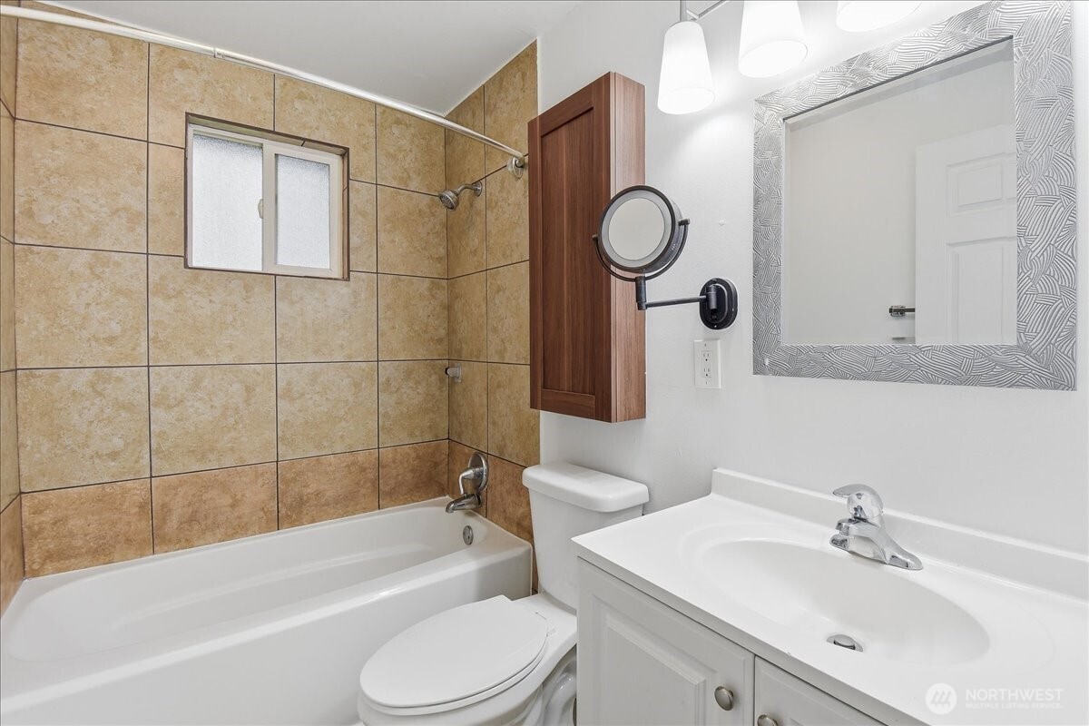 4404 Southeast 3rd Place Renton, WA 98059 - Photo 15 of 27 a bathroom with a bathtub shower sink vanity and toilet