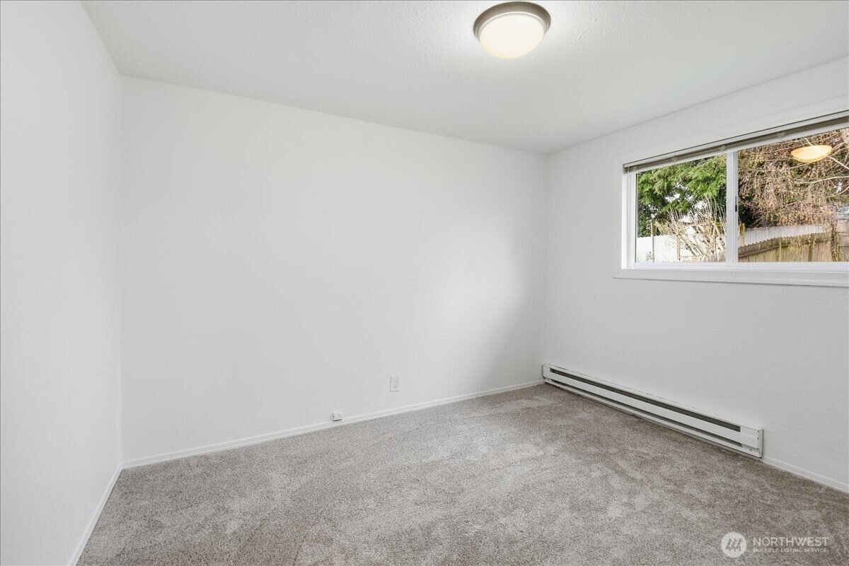 4404 Southeast 3rd Place Renton, WA 98059 - Photo 19 of 27 an empty room with a window