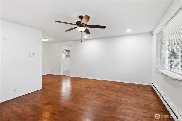 wooden floor in an empty room with a window