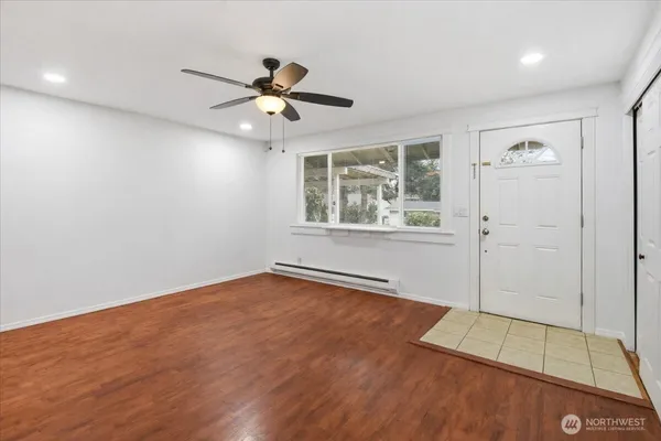 wooden floor in an empty room with a window