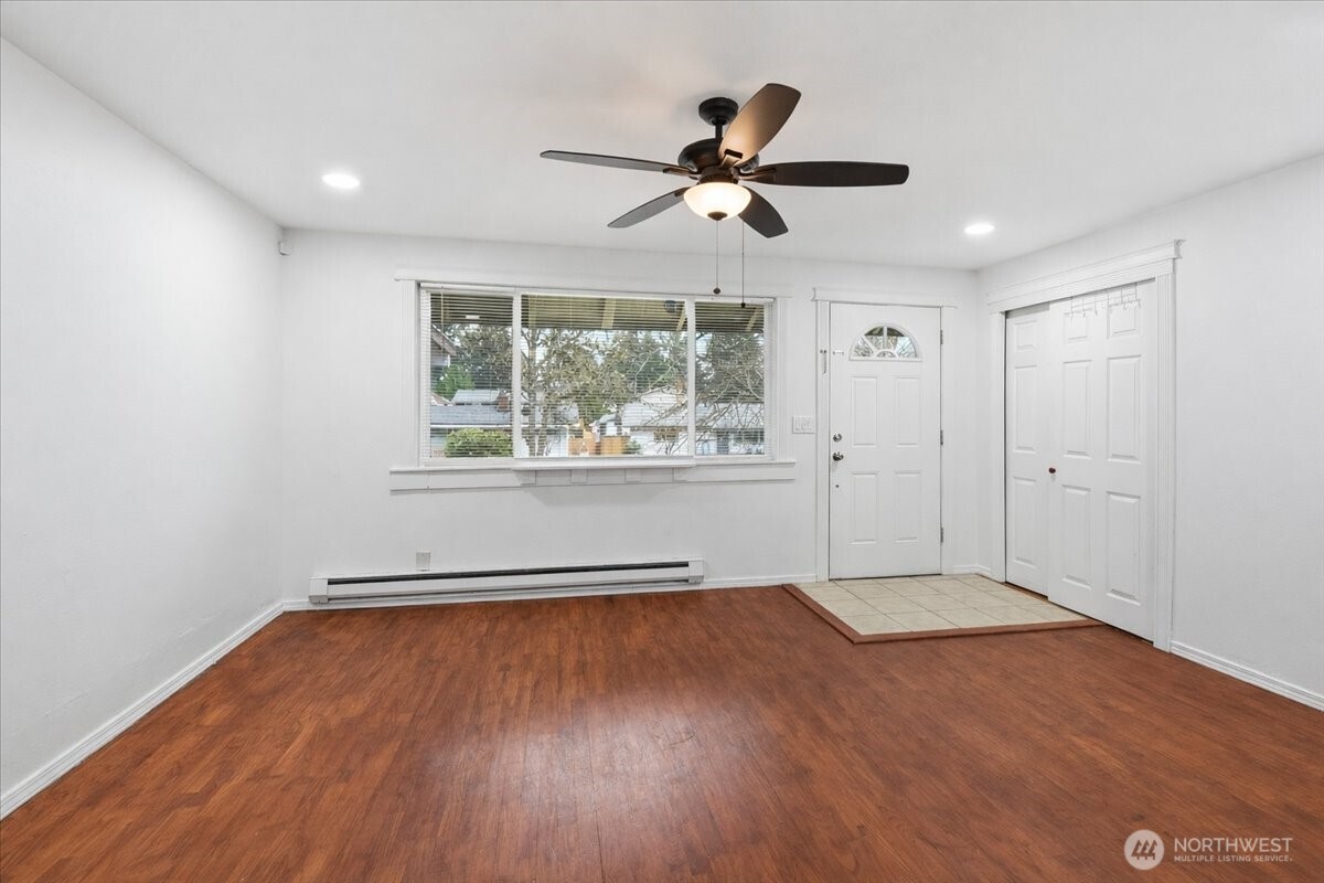 4404 Southeast 3rd Place Renton, WA 98059 - Photo 5 of 27 a view of empty room with wooden floor and fan