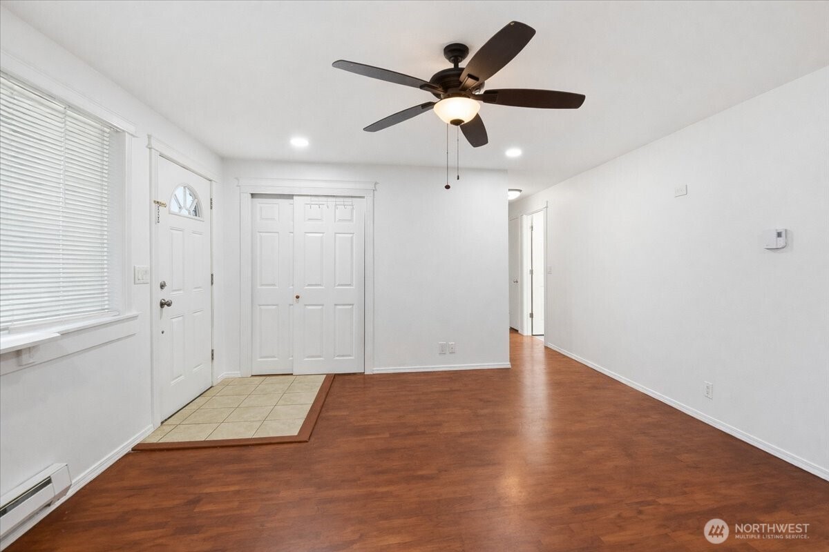 4404 Southeast 3rd Place Renton, WA 98059 - Photo 6 of 27 an empty room with wooden floor and ceiling fan