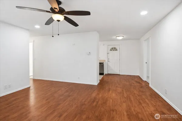 a view of empty room with wooden floor