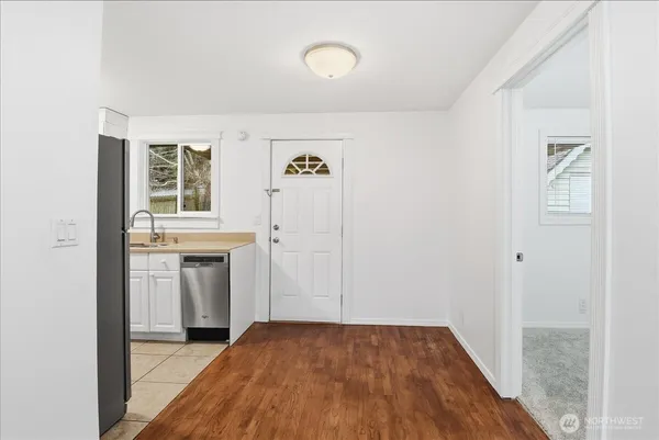 a view of walk in closet with window and wooden floor