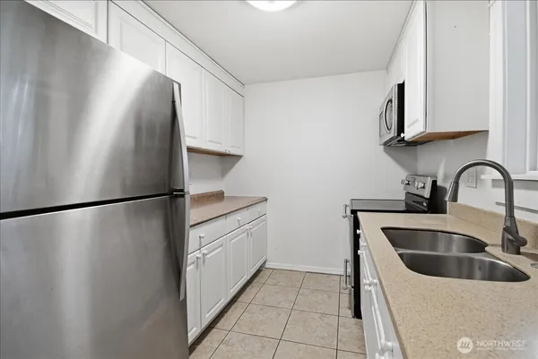 a kitchen with stainless steel appliances a refrigerator and a sink