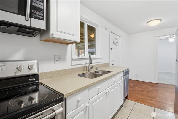 a kitchen with a sink stove and cabinets