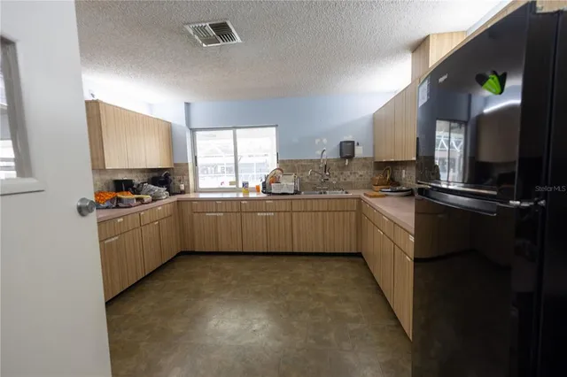 a kitchen with a sink a counter top space cabinets and appliances