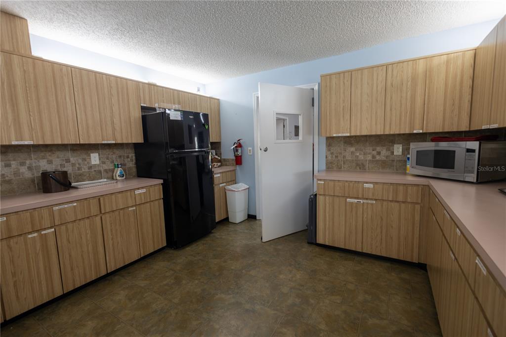 0 Forest Glenn Drive Spring Hill, FL 34607 - Photo 18 of 31 a kitchen with a refrigerator sink and cabinets