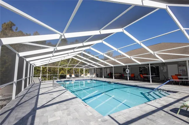 a view of a yard with table and chairs under an umbrella
