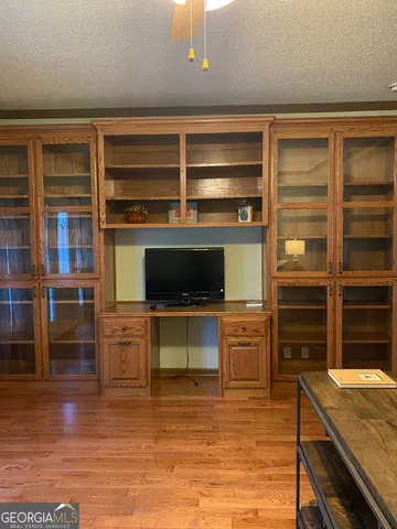 a living room with flat screen tv and washer