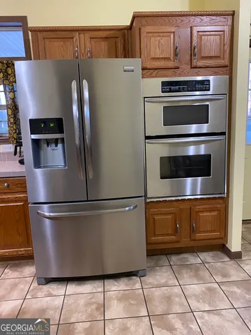 a white refrigerator freezer and a stove sitting inside of a kitchen