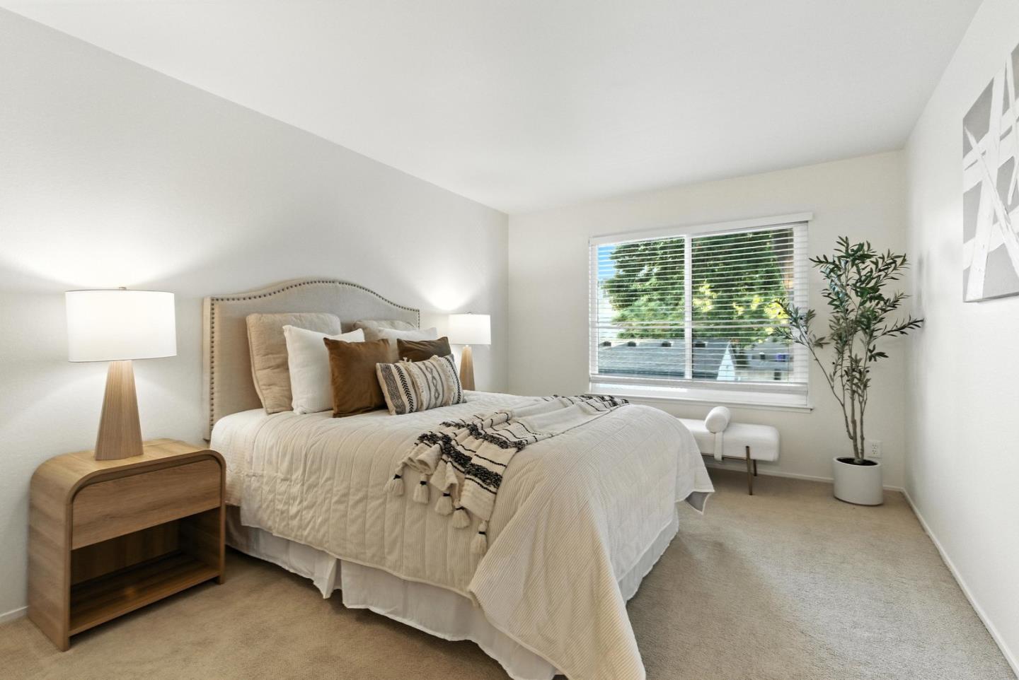 905 West Middlefield Road, Unit 974 Mountain View, CA 94043 - Photo 12 of 20 a bedroom with a large bed and a lamp
