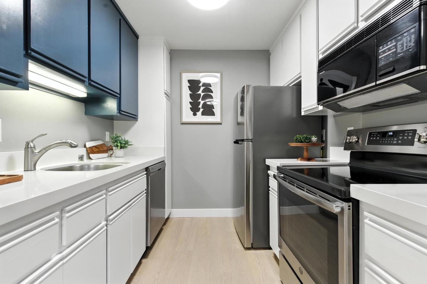905 West Middlefield Road, Unit 974 Mountain View, CA 94043 - Photo 9 of 20 a kitchen with stainless steel appliances granite countertop a refrigerator sink and stove