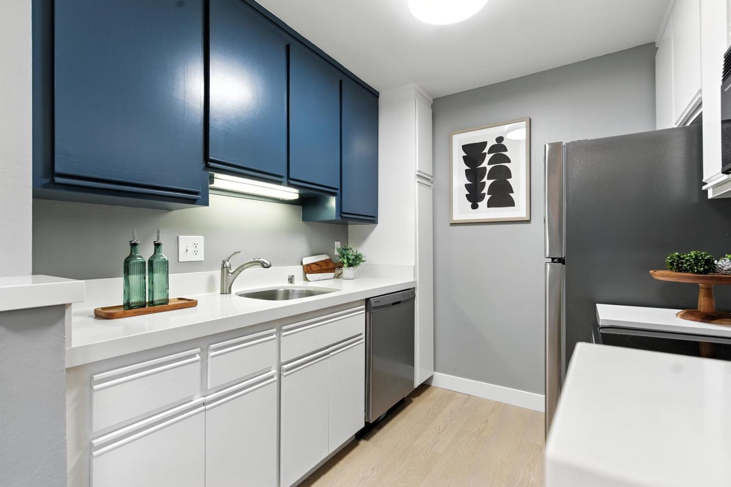 905 West Middlefield Road, Unit 974 Mountain View, CA 94043 - Photo 10 of 20 a kitchen with stainless steel appliances granite countertop a sink stove and cabinets