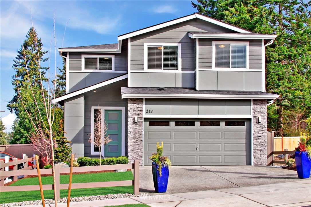 18631 Meridian Place West, Unit CC 10 Bothell, WA 98012 - Photo 1 of 27 a front view of a house with a yard and garage