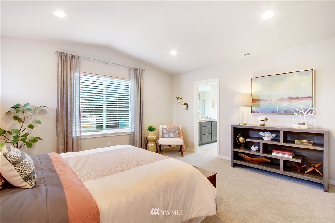 18631 Meridian Place West, Unit CC 10 Bothell, WA 98012 - Photo 15 of 27 a bedroom with a bed and a painting on the wall