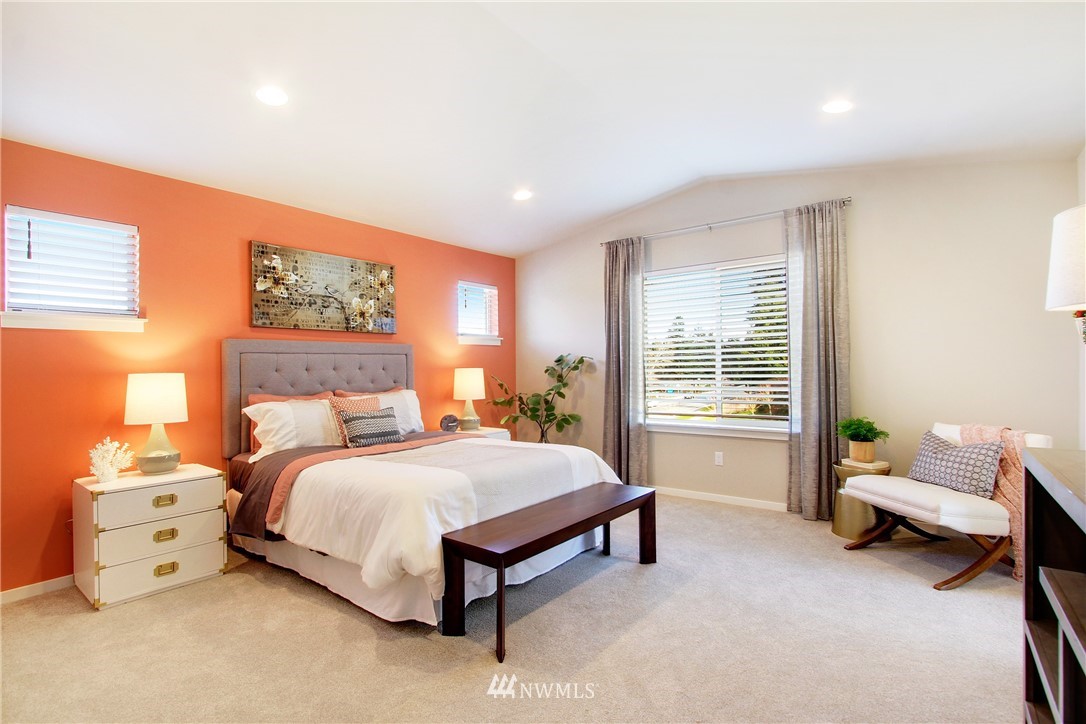 18631 Meridian Place West, Unit CC 10 Bothell, WA 98012 - Photo 16 of 27 a bedroom with a bed and a chair