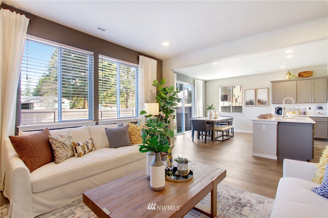 18631 Meridian Place West, Unit CC 10 Bothell, WA 98012 - Photo 6 of 27 a living room with furniture and potted plant with kitchen view