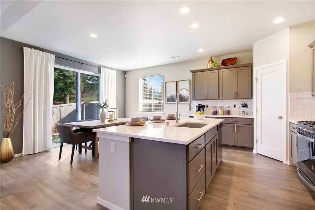 18631 Meridian Place West, Unit CC 10 Bothell, WA 98012 - Photo 10 of 27 a kitchen with a sink stove and cabinets
