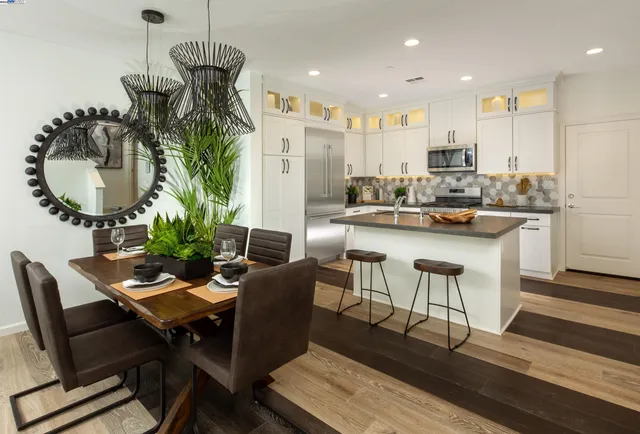 a dining room with furniture and a chandelier
